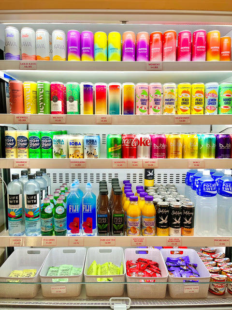 Shelf stocked with various drinks and products in a store setting